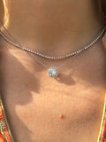 rose gold diamond choker necklace layered with a diamond solitiare ballerina pendant. close up shot of models  neck